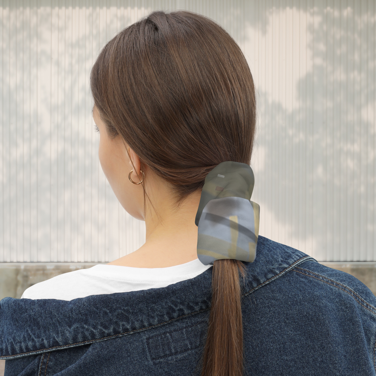 Urban Concrete 7 neck gaiter used as a ponytail wrap with a denim jacket, rear view.