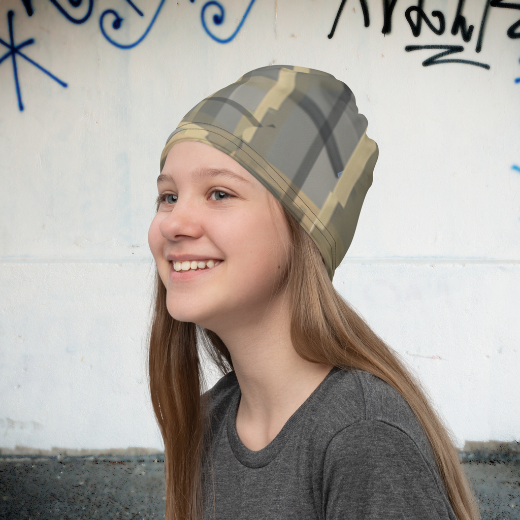 Urban Concrete 7 neck gaiter worn as a beanie beside a graffiti-covered wall.