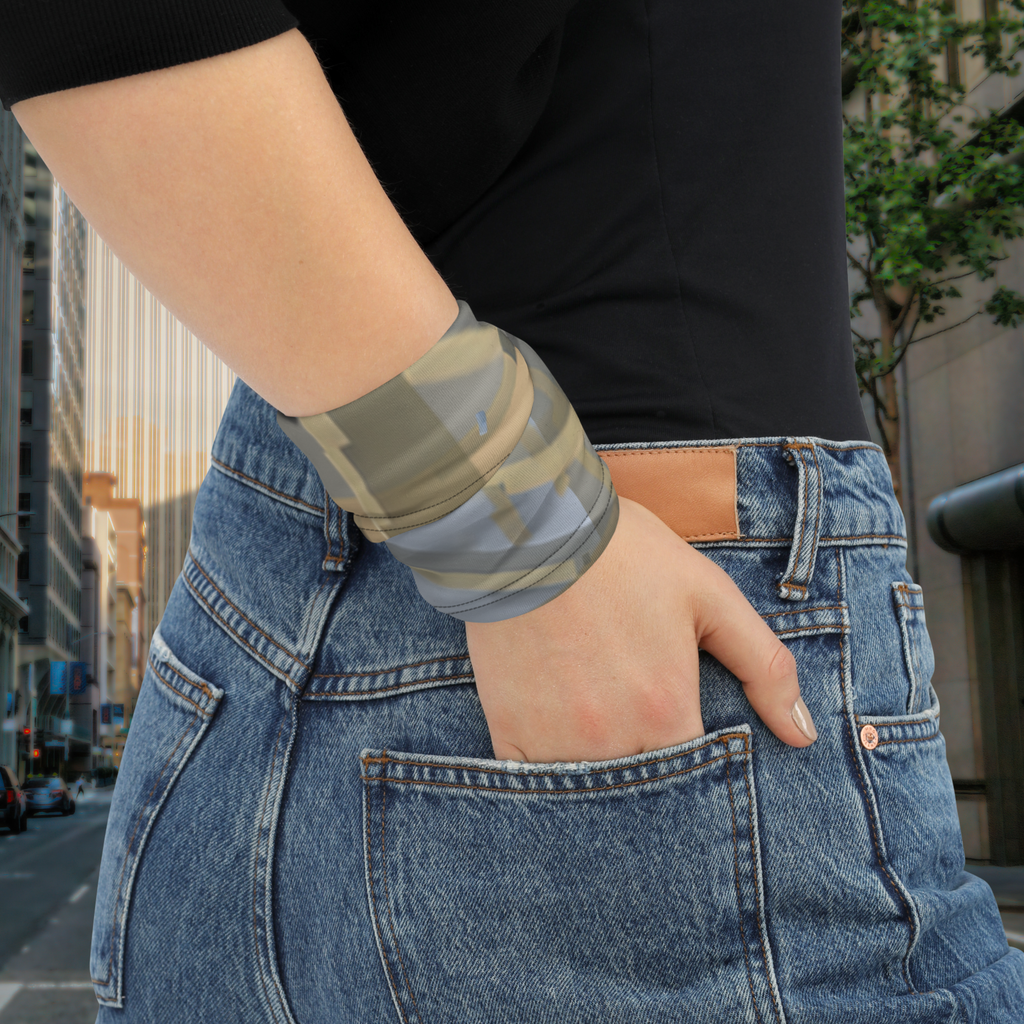 Urban Concrete 7 neck gaiter wrapped around the wrist beside blue jeans.
