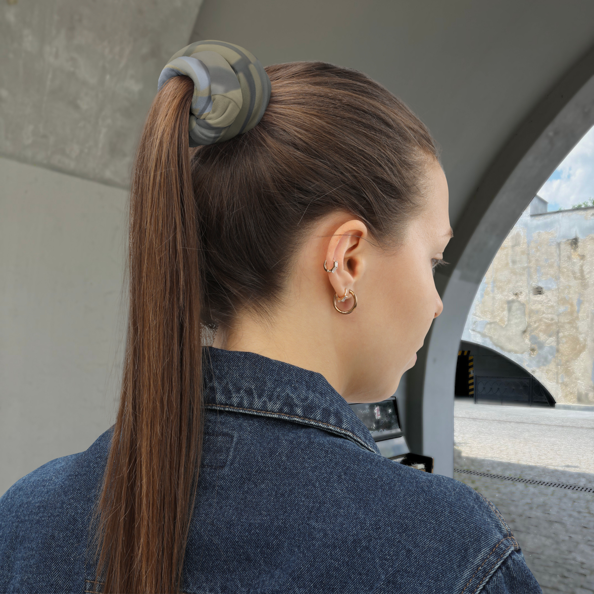 Urban Concrete 7 neck gaiter used to secure a high ponytail, rear side view.
