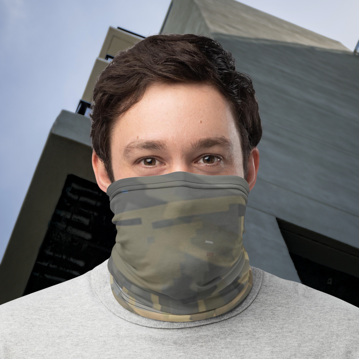 Urban Concrete 7 neck gaiter worn over the nose and mouth outside a concrete building.