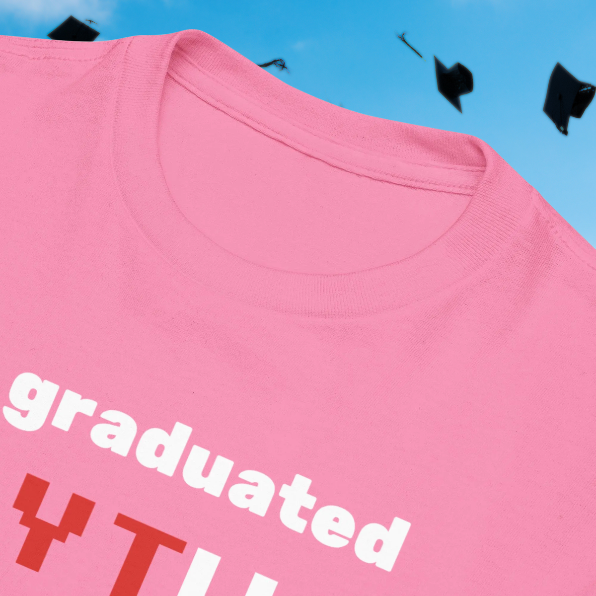 I Graduated YTU kids' T-shirt in pink, close-up of the collar and slogan.