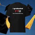 I Graduated YTU T-shirt in black, front product view against graduation caps and tassels.