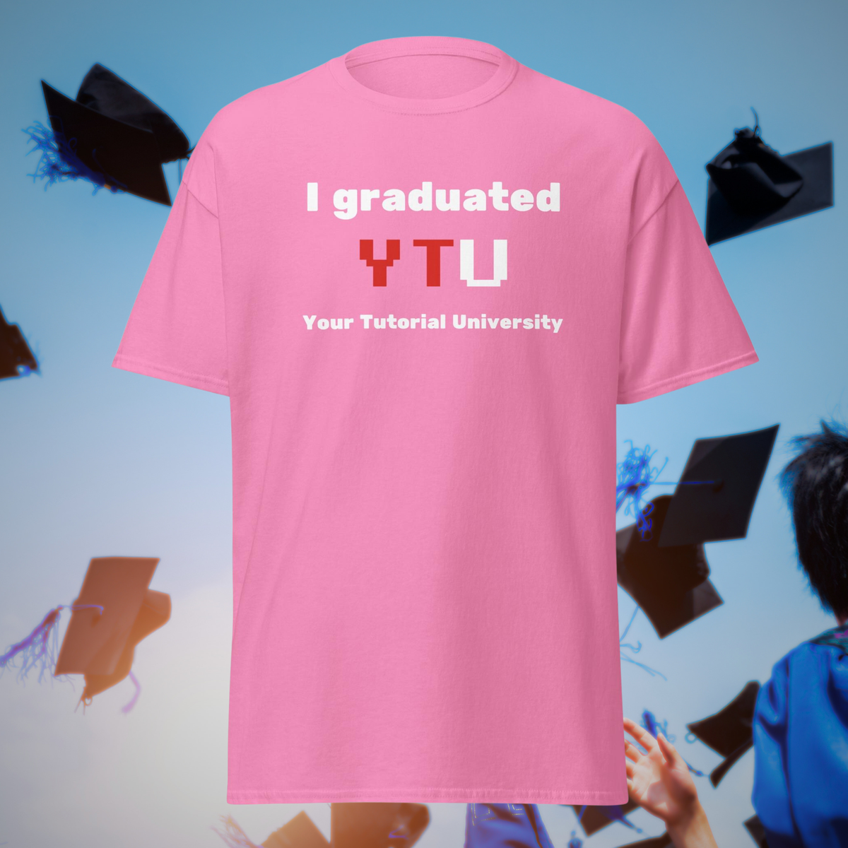 I Graduated YTU T-shirt in pink, front product view against flying graduation caps.