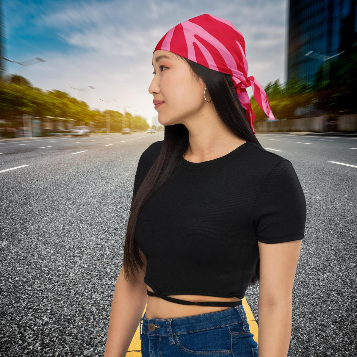 Pink Zebra bandana worn as a headscarf on a city street, side view.