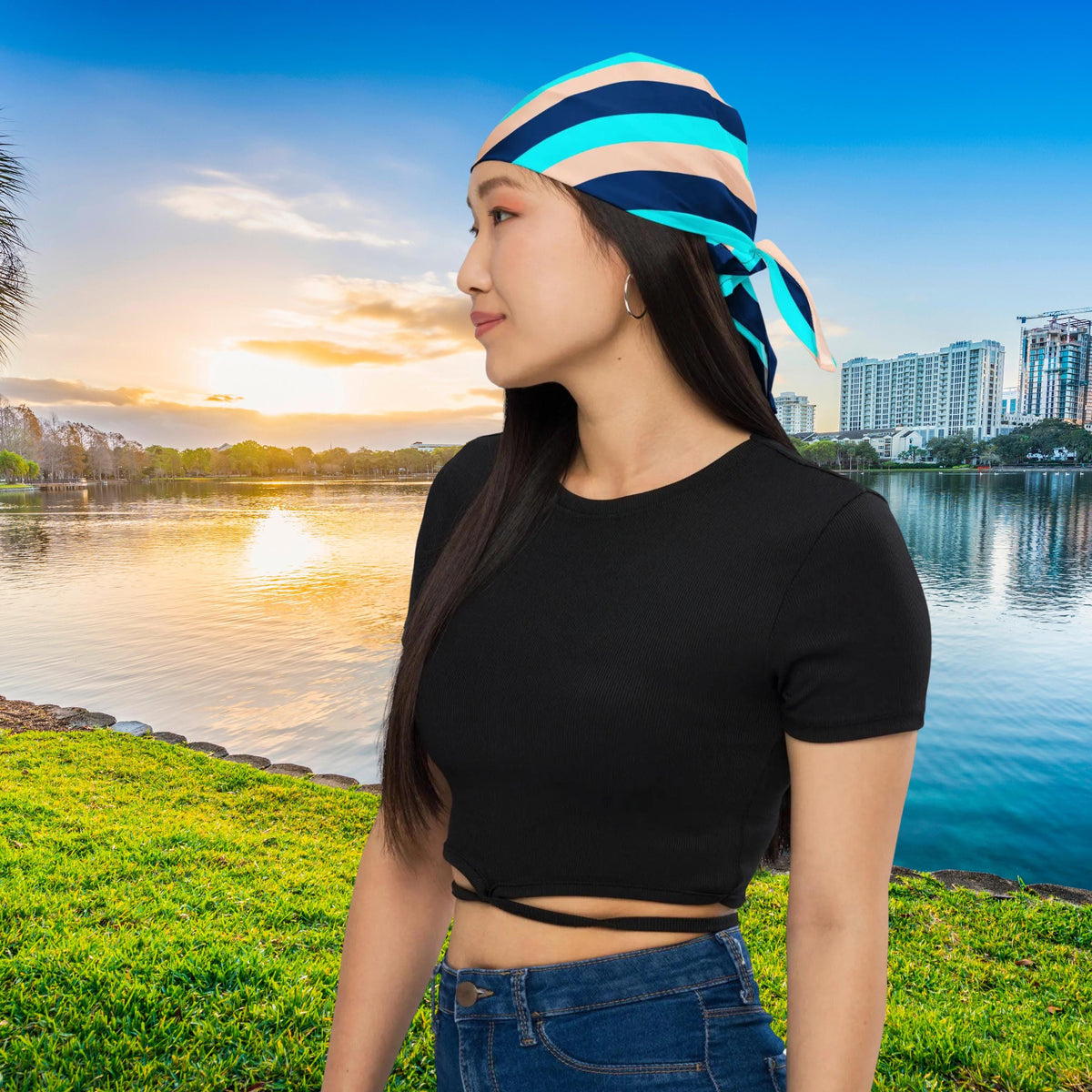 Blue Stripe bandana worn as a headscarf beside an urban lake.