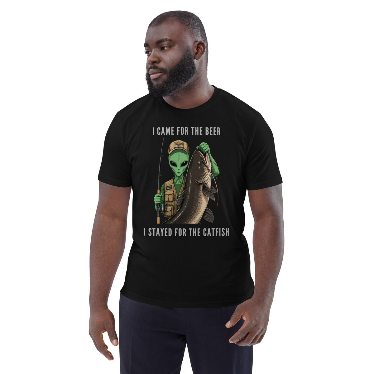 Alien Catfish fishing T-shirt in black, worn by a model with dark trousers on white.