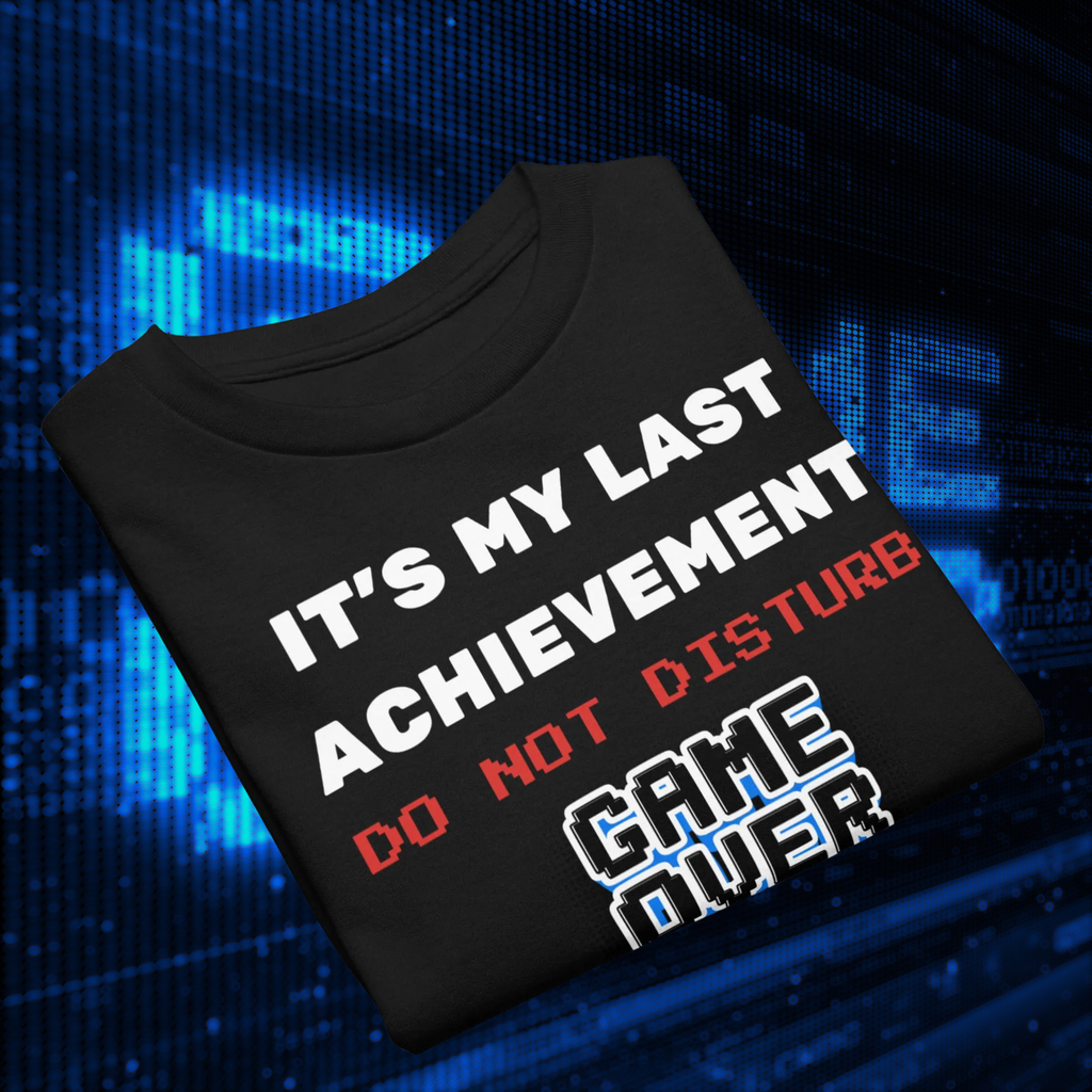 It's My Last Achievement kids' gamer T-shirt in black, folded against blue pixel lights.