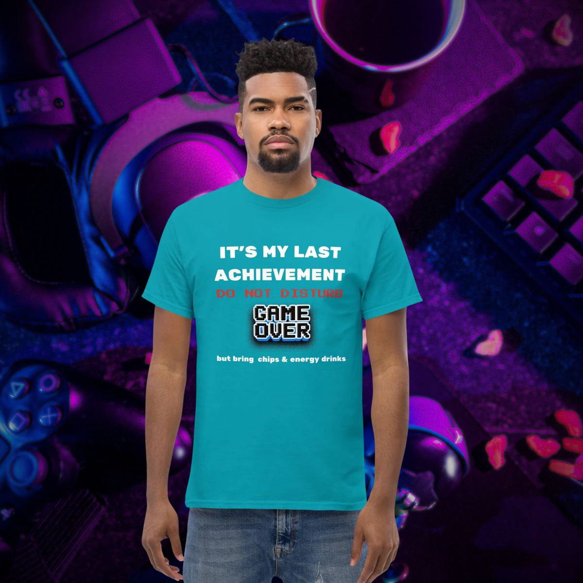 It's My Last Achievement gamer T-shirt in turquoise, worn by a model against a purple controller backdrop.