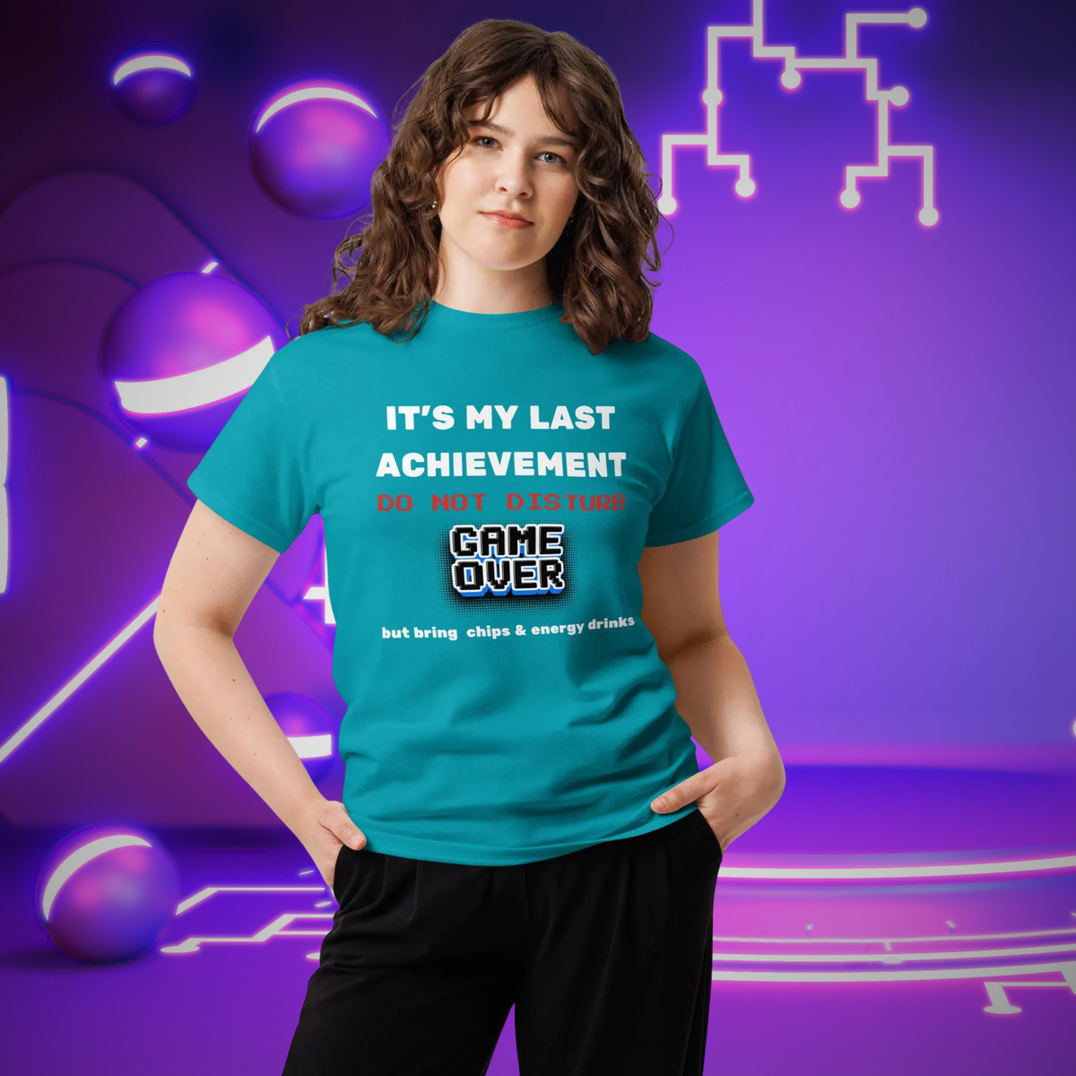 It's My Last Achievement gamer T-shirt in turquoise, worn by a model against purple pixel graphics.
