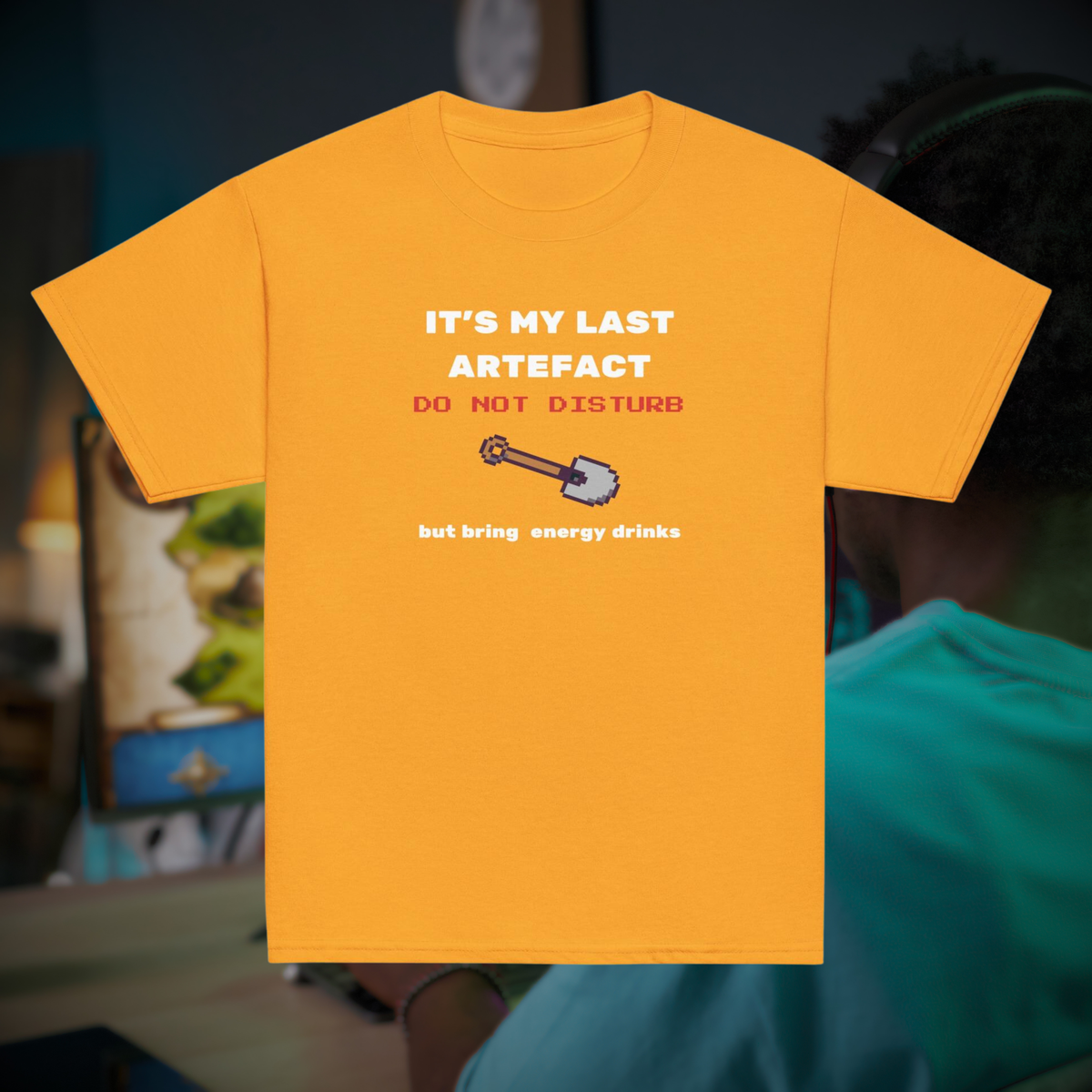 It's My Last Artefact kids' gamer T-shirt in gold, front product view against a gaming setup.