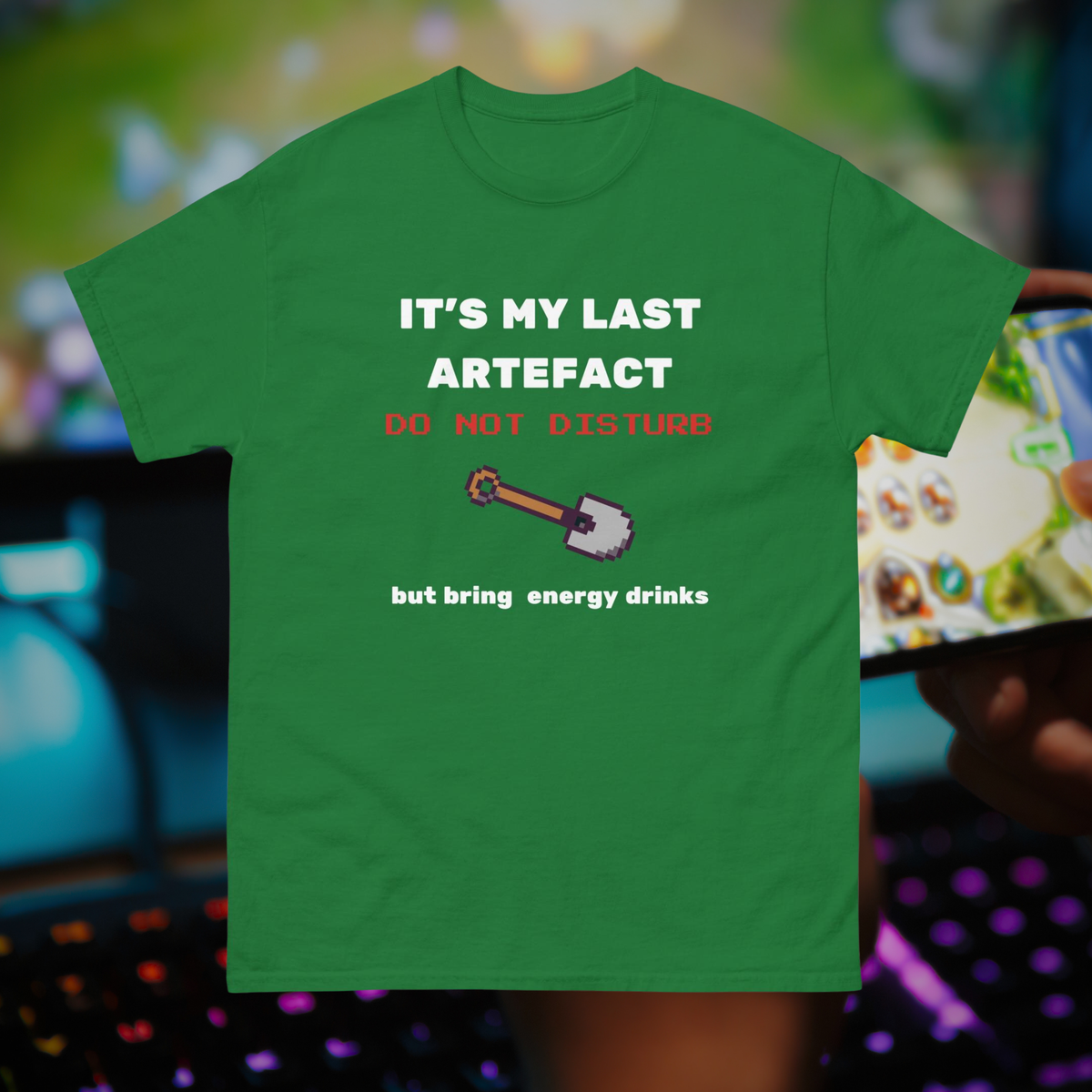 It's My Last Artefact gamer T-shirt in green, front product view against a gaming setup.