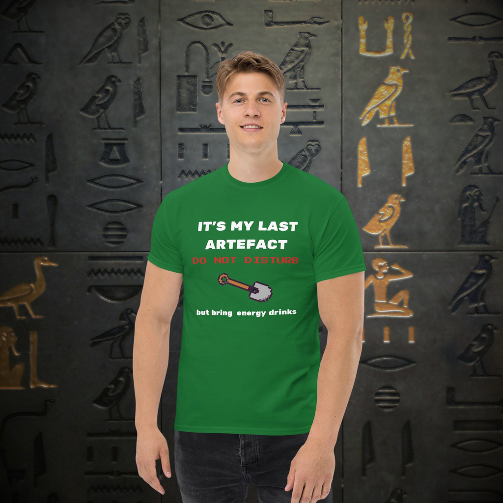 It's My Last Artefact gamer T-shirt in green, worn by a model against a hieroglyph-pattern backdrop.