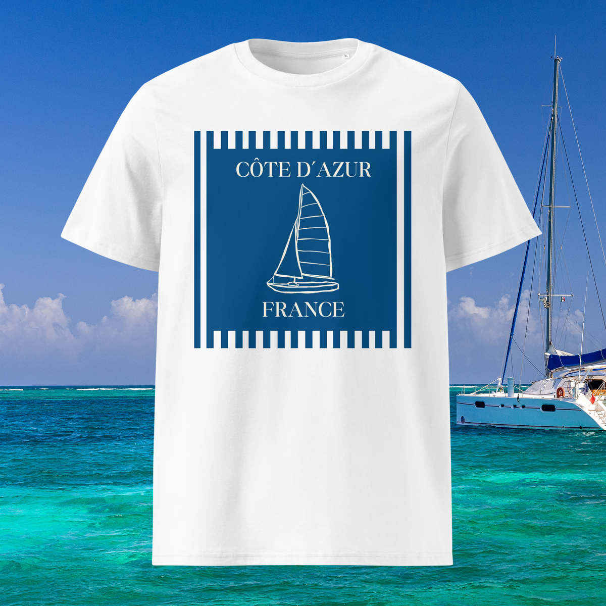 Côte d'Azur sailboat T-shirt in white, front product view with blue sailboat artwork against a sea backdrop.