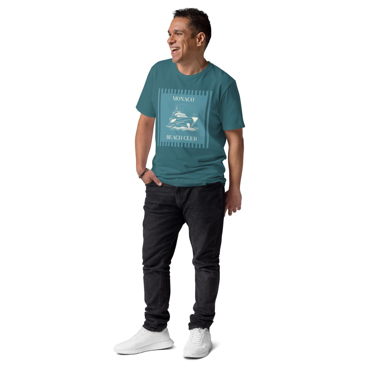 Monaco Beach Club T-shirt in teal, full-length view on a model with black trousers.