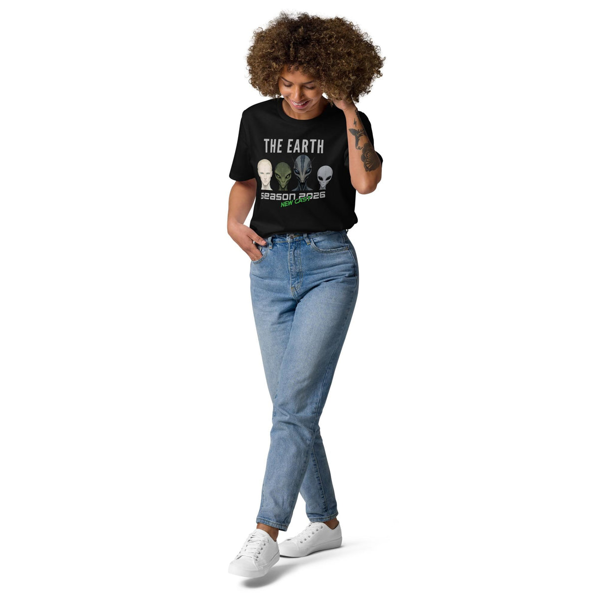 The Earth Season 2026 alien T-shirt in black, full-length view on a model with blue jeans.