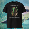 Alien Catfish fishing T-shirt in black, front product view showing the alien holding a catfish.