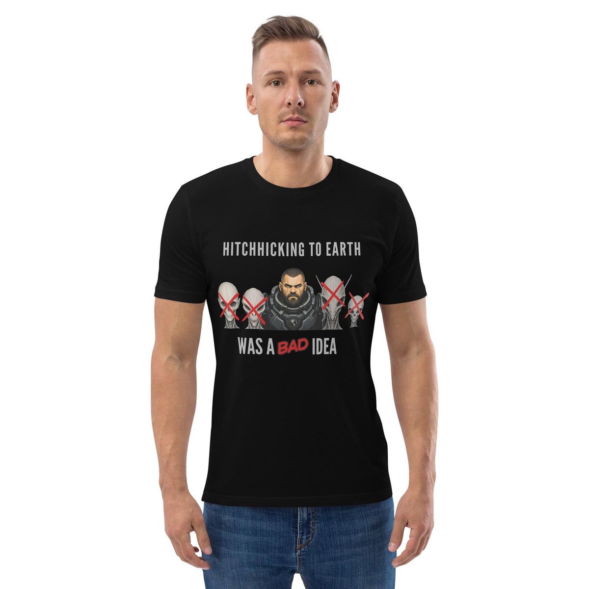 Alien Hitchhiking T-shirt in black, worn by a model with hands in pockets, front view.