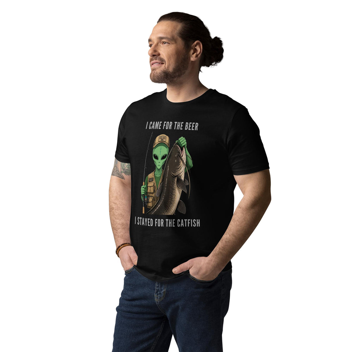 Alien Catfish fishing T-shirt in black, worn by a model with hands in pockets, three-quarter view.