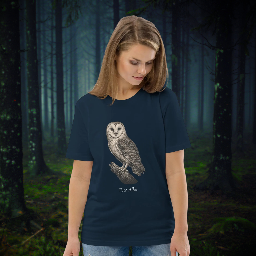 Vintage Barn Owl T-shirt in navy, worn by a model looking down at the owl graphic in a forest.