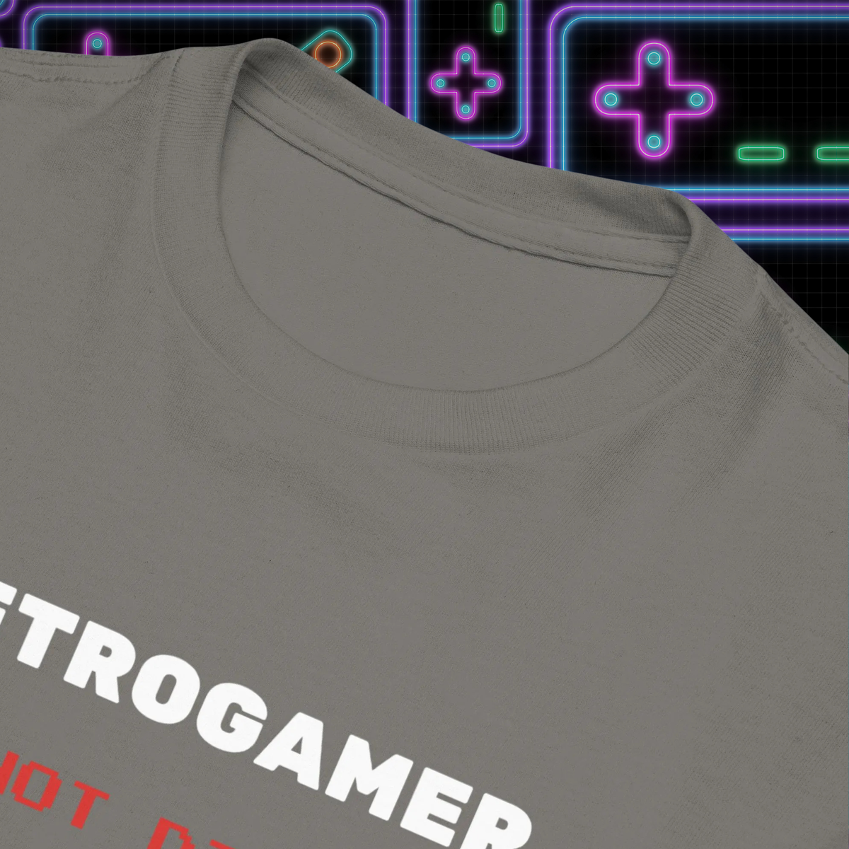 Retrogamer kids' T-shirt in charcoal, close-up of the collar and slogan against neon graphics.