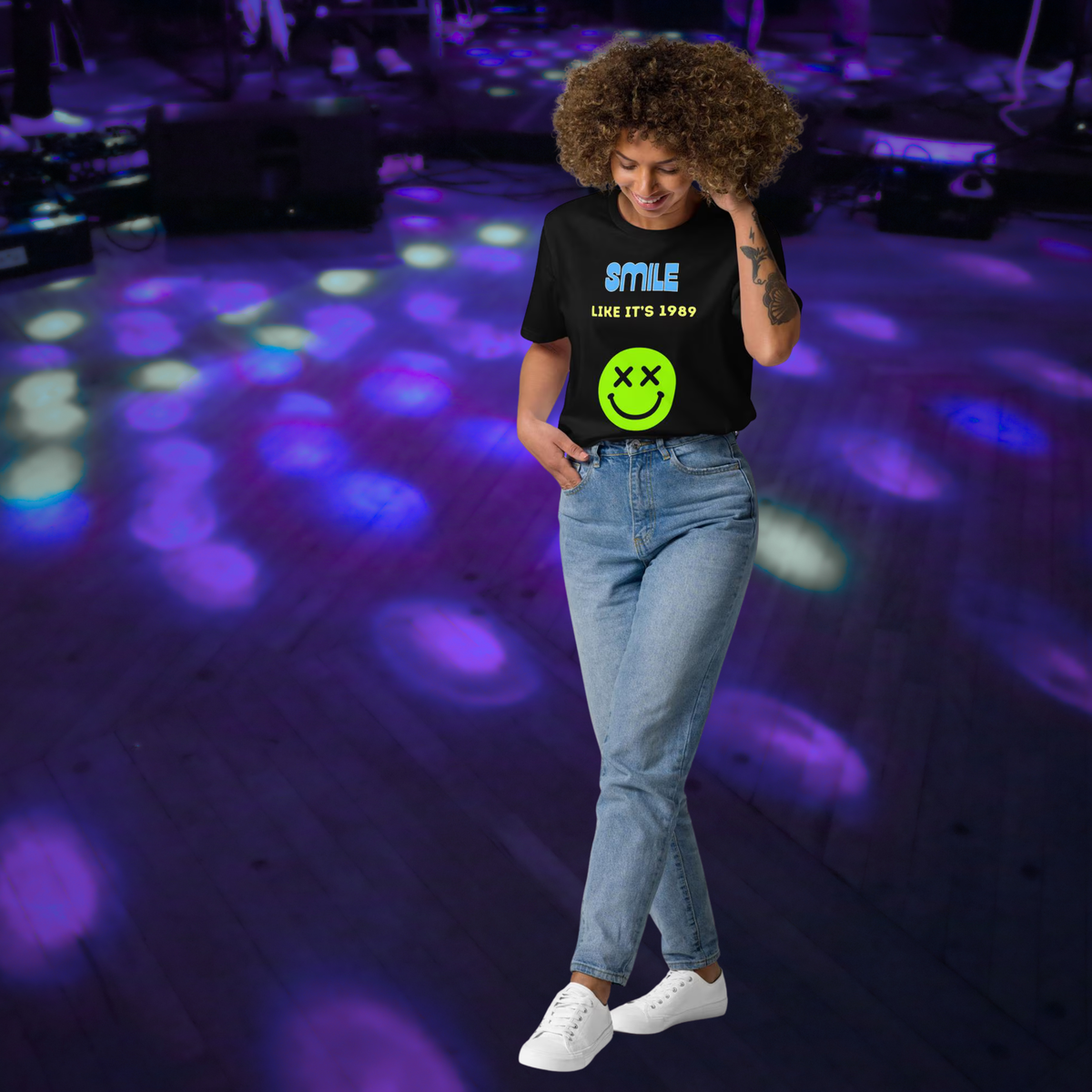 Smile Like It's 1989 rave T-shirt in black, full-length view on a model against purple club lights.