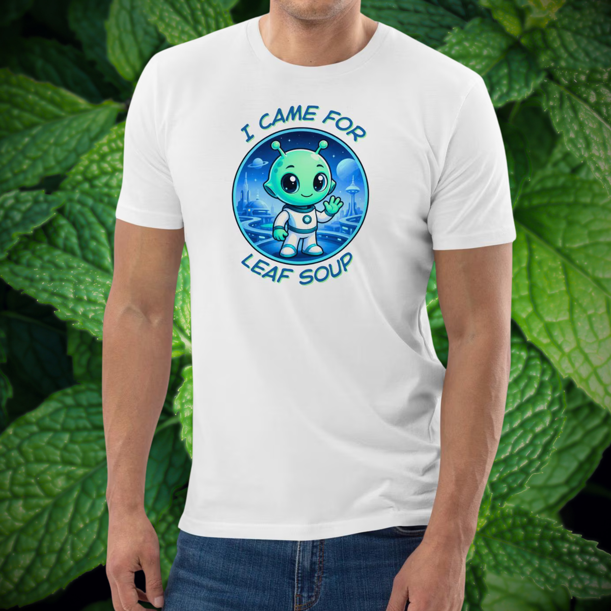 Alien Leaf Soup T-shirt in white, torso view against a leafy green backdrop.