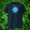 Alien Leaf Soup T-shirt in navy, front product view of the tea-drinking alien against green leaves.