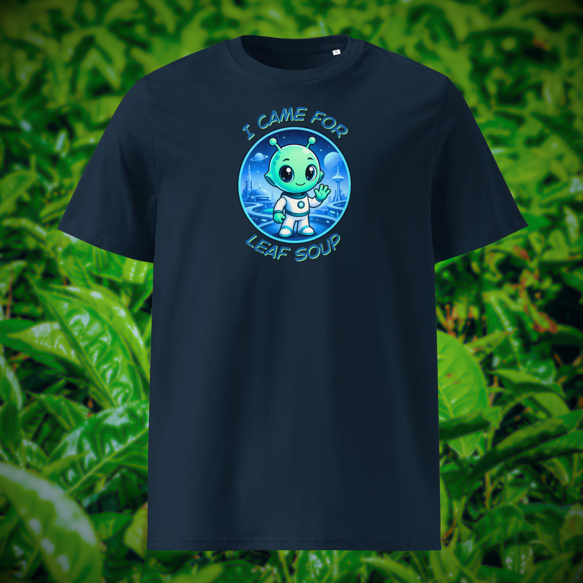 Alien Leaf Soup T-shirt in navy, front product view of the tea-drinking alien against green leaves.