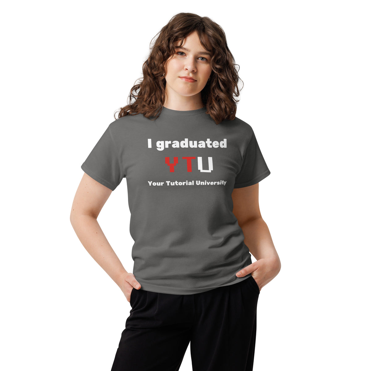 I Graduated YTU T-shirt in charcoal, worn by a model with hands in pockets on white.